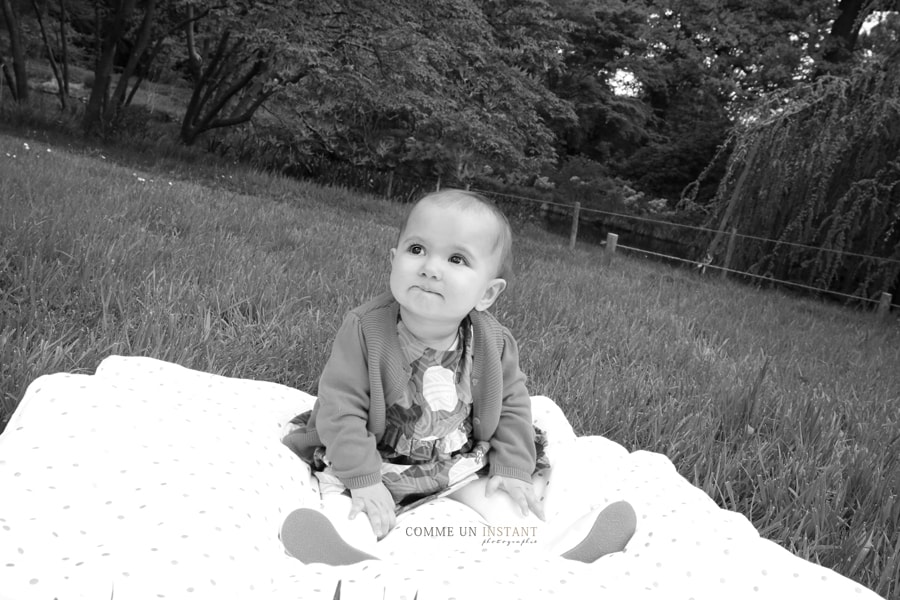 photographe a domicile bébé en train de jouer - shooting de bébés - noir et blanc - photographe professionnelle bébé en extérieur - reportage photographe bébé